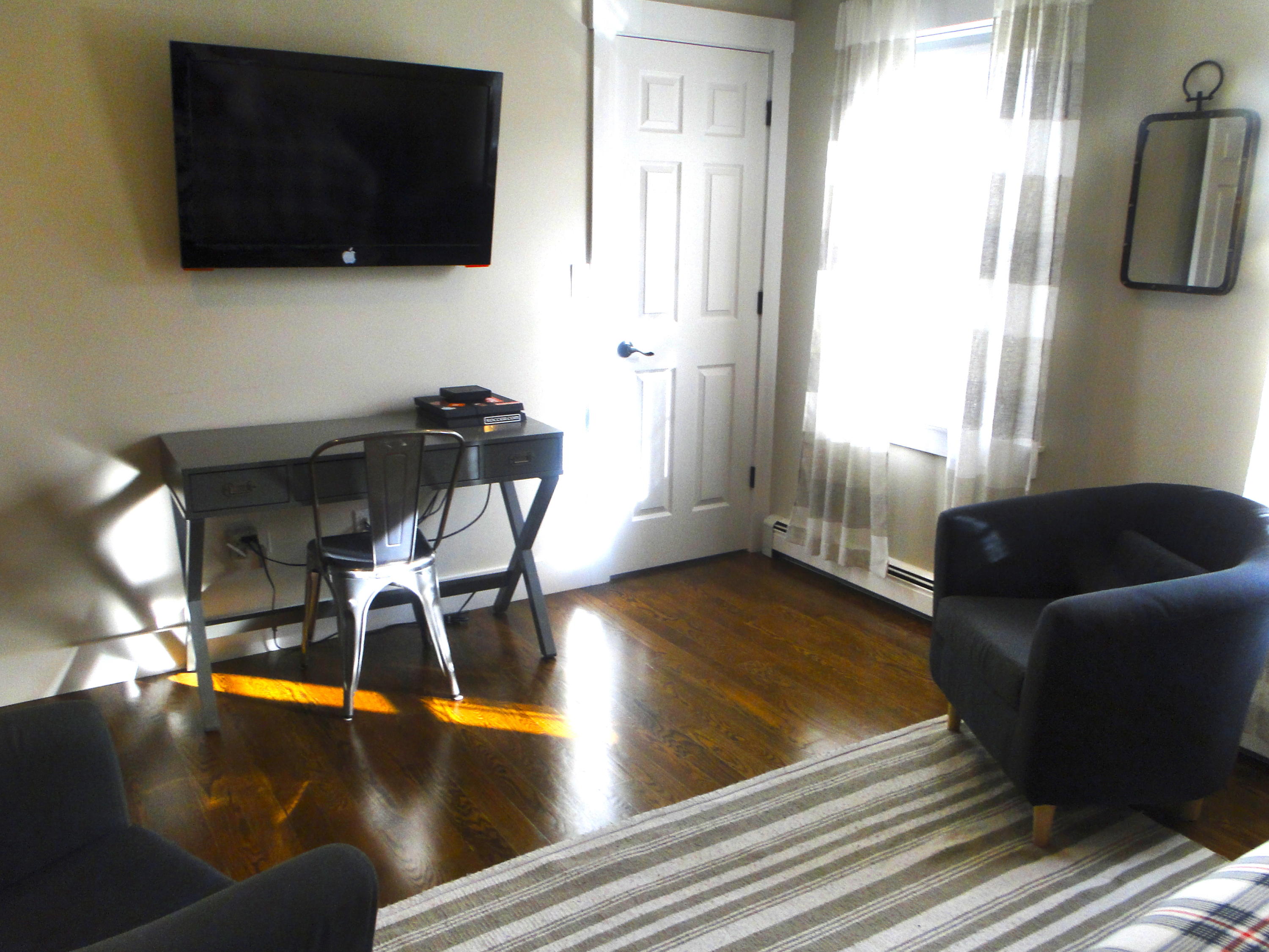 30 Brewster Road Mashpee, MA 02649 - Photo 42 of 58 a living room with furniture and a flat screen tv