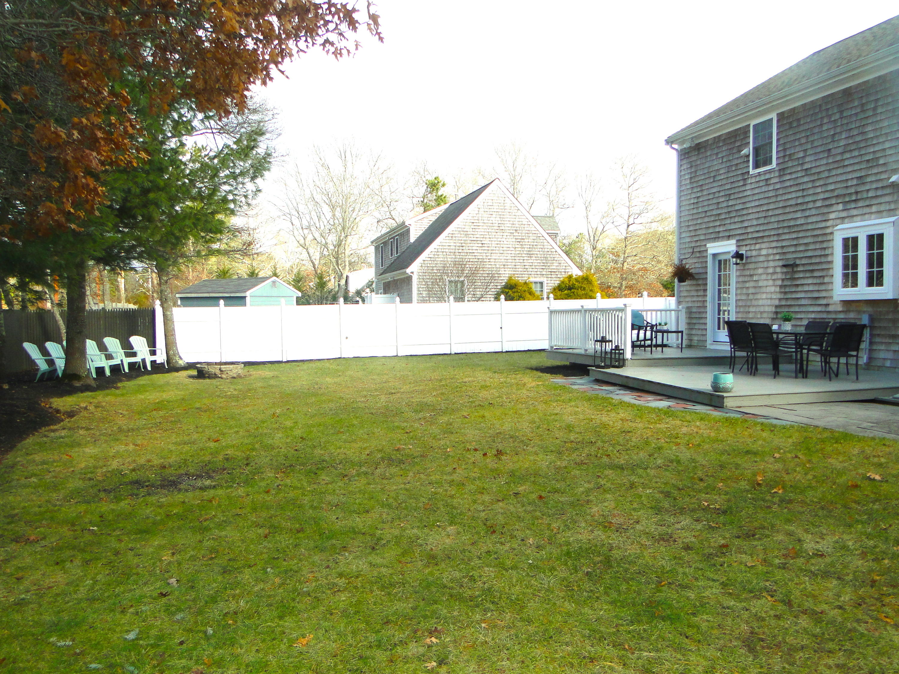 30 Brewster Road Mashpee, MA 02649 - Photo 52 of 58 a view of pool with lawn chairs and large trees
