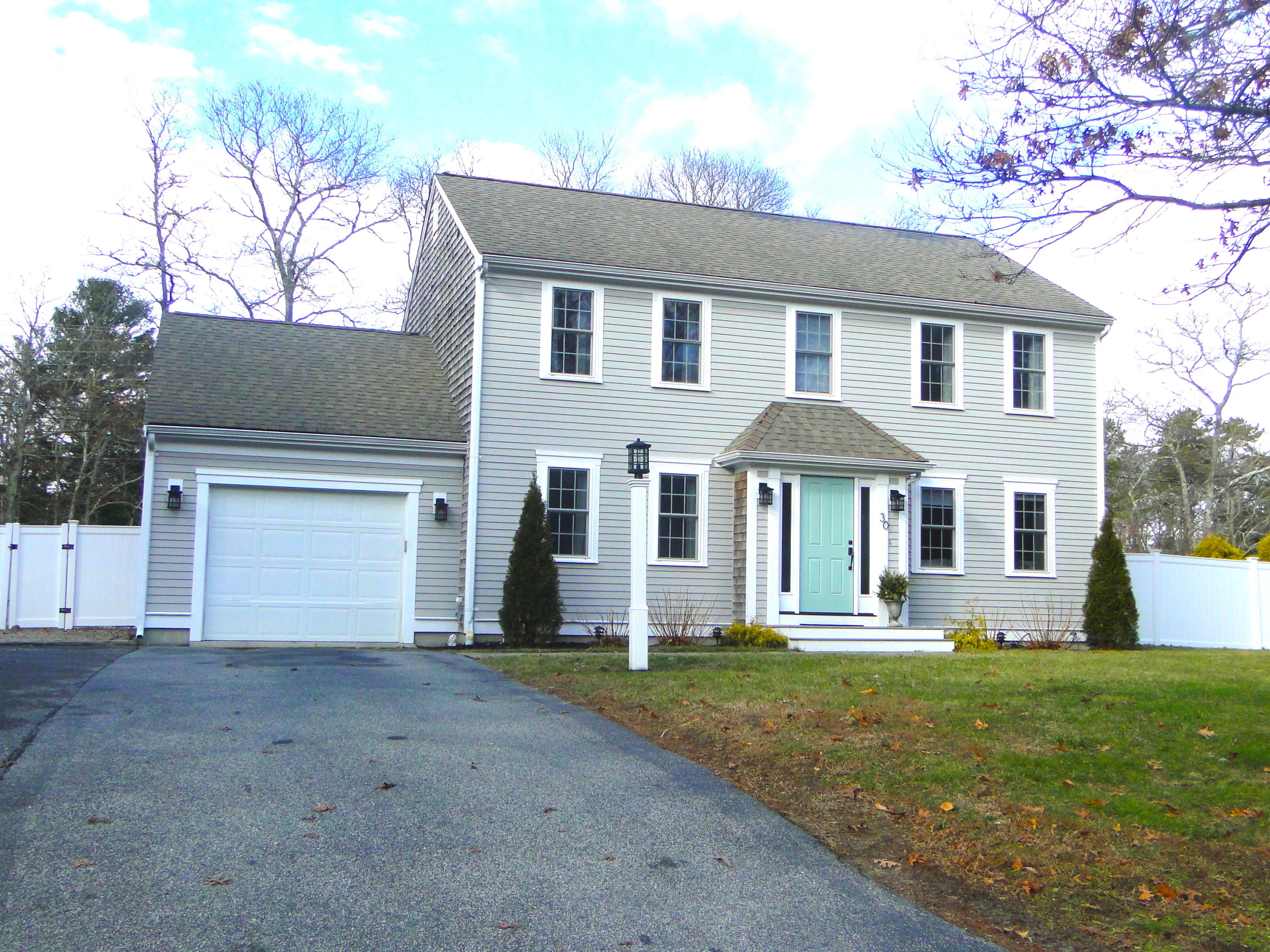 30 Brewster Road Mashpee, MA 02649 - Photo 55 of 58 a front view of a house with a yard