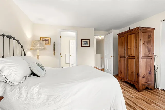 a large bed sitting in a bedroom and a table