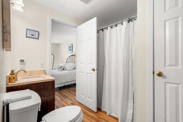 a bathroom with a toilet sink vanity tub and shower