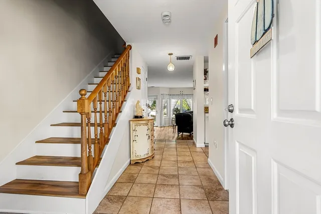 a view of entryway and hall with wooden floor