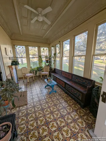 a living room with furniture rug and a large window