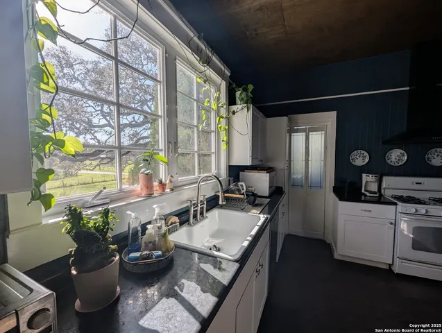 a kitchen with a sink appliances and cabinets