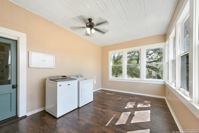 a kitchen with stainless steel appliances granite countertop a stove a refrigerator and a chandelier