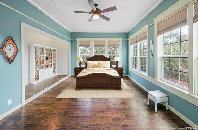 a bedroom with a bed and a large window