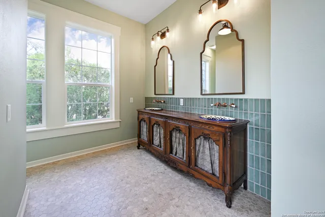 a bathroom with a sink a mirror and a window