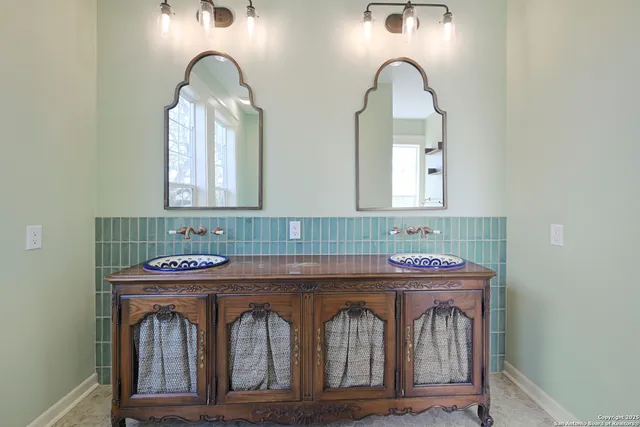 a bathroom with a granite countertop sink a mirror and vanity