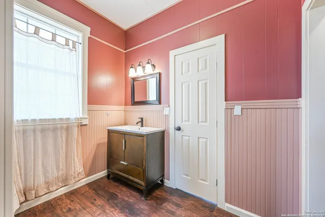 a bathroom with a sink a mirror and a window