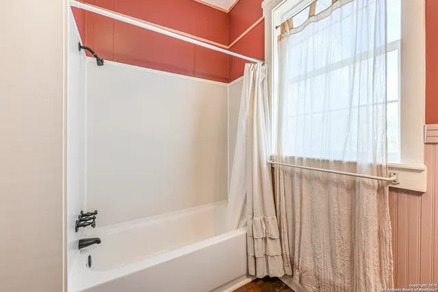 a bathroom with a shower and a tub