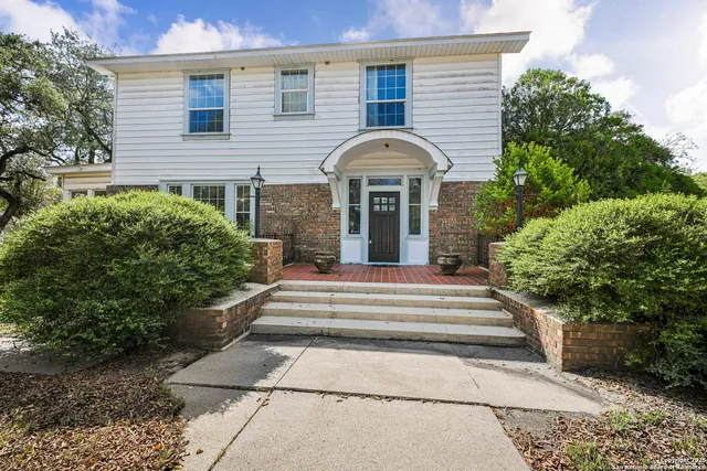 a view of a house with potted plants