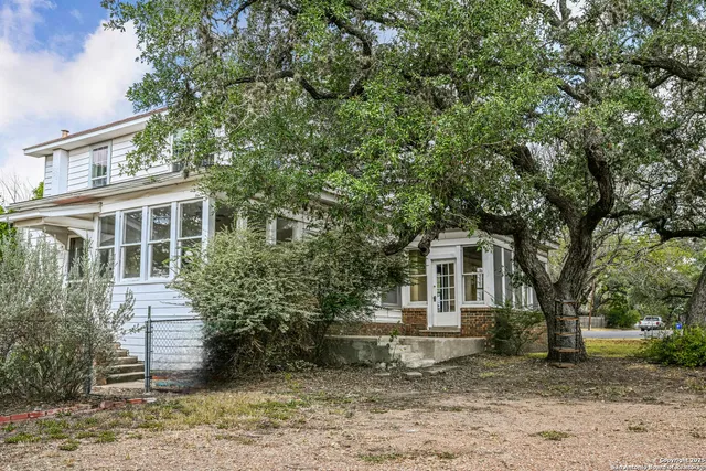 front view of a house with a tree