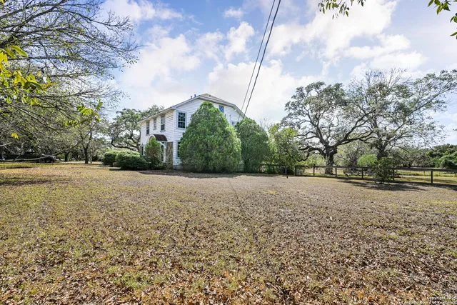 a view of dirt yard with a fountain