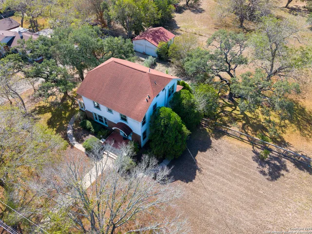 an aerial view of house with yard