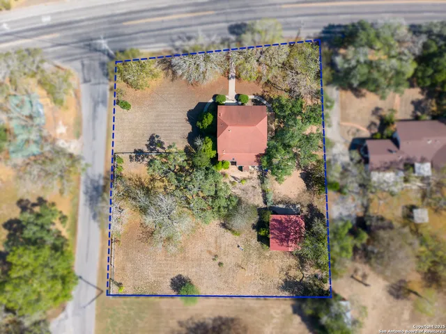 an aerial view of a house with a yard