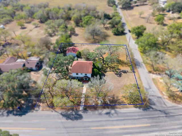 an aerial view of a house with a yard