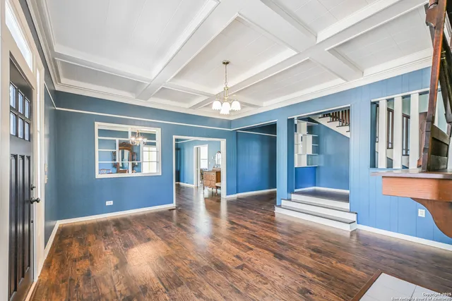 a view of an entryway with wooden floor and livingroom view