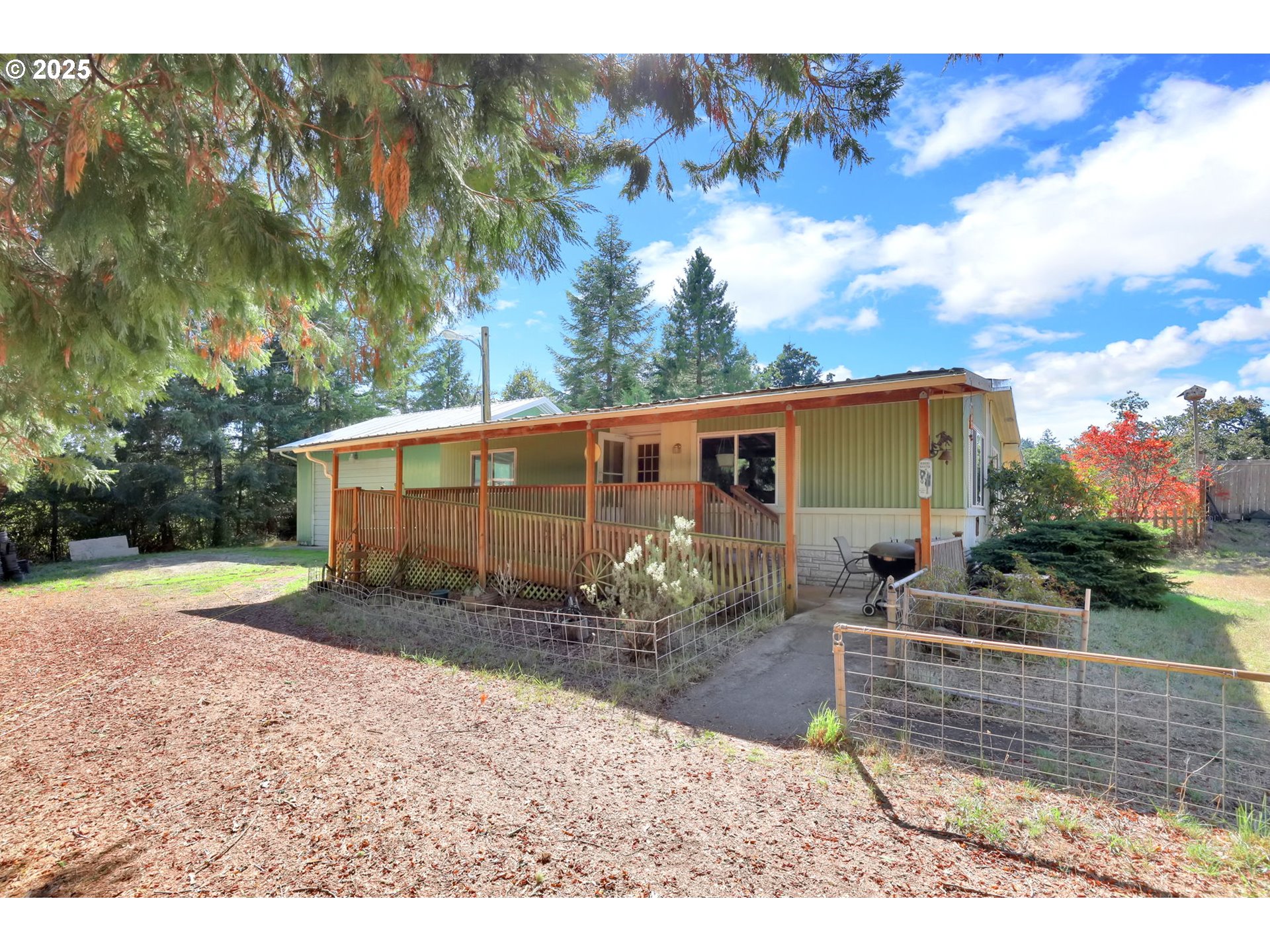 a backyard of a house with table and chairs