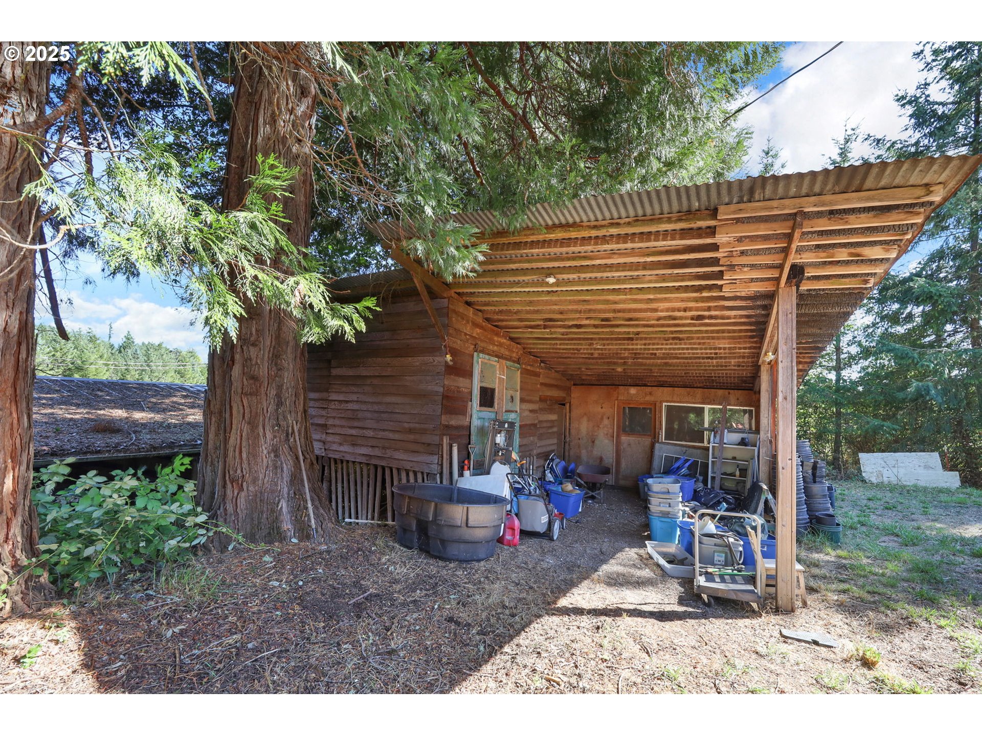 31145 Kenady Lane Cottage Grove, OR 97424 - Photo 39 of 47 a view of a patio with a table and chairs under an umbrella