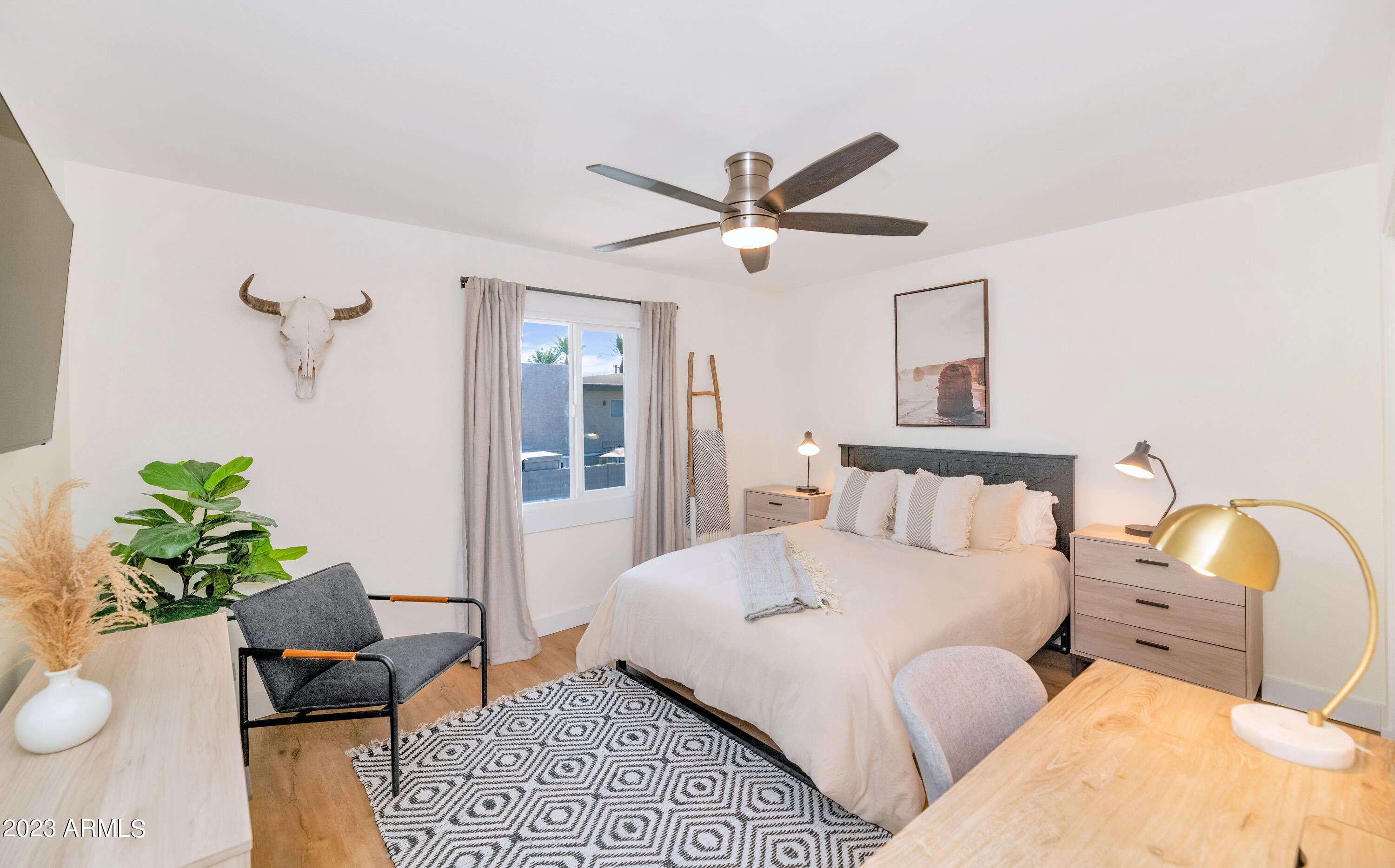 4201 East Camelback Road, Unit 90 Phoenix, AZ 85018 - Photo 17 of 30 a bedroom with a bed furniture and a window