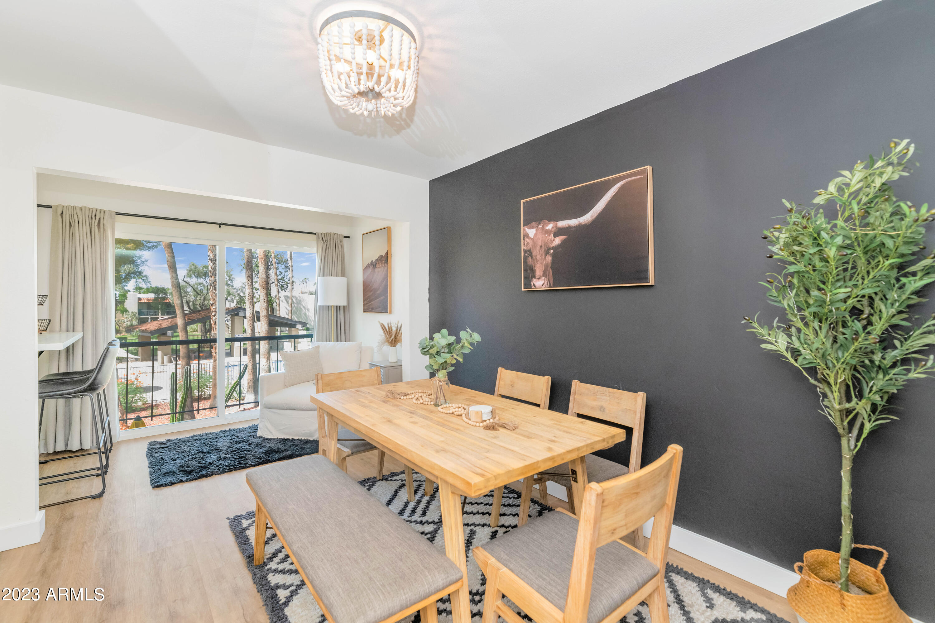 4201 East Camelback Road, Unit 90 Phoenix, AZ 85018 - Photo 7 of 30 a view of a dining room with furniture window and wooden floor