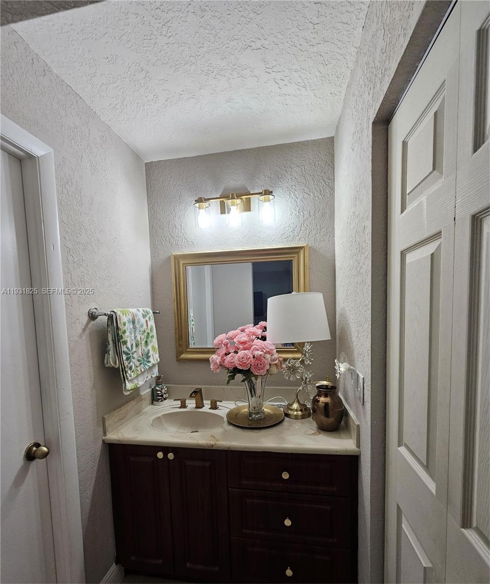 8401 Southwest 107th Avenue, Unit 117E Miami, FL 33173 - Photo 7 of 9 a bathroom with a sink and a mirror