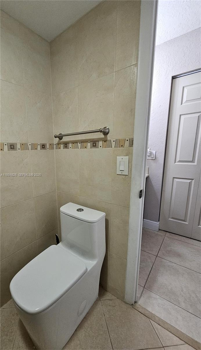 8401 Southwest 107th Avenue, Unit 117E Miami, FL 33173 - Photo 8 of 9 a bathroom with a toilet and a shower
