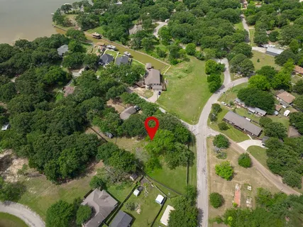 an aerial view of residential houses with outdoor space and street view