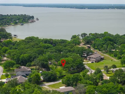 an aerial view of house with outdoor space and lake view