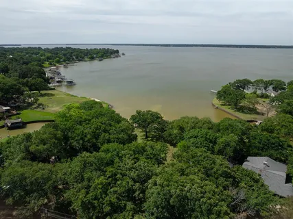 an aerial view of a houses with a lake view