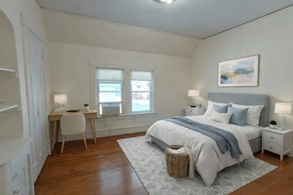 a bedroom with a bed and a chair