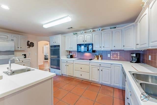 6209 Point La Vista Road Malakoff, TX 75148 - Photo 6 of 38 a kitchen with granite countertop white cabinets and white appliances