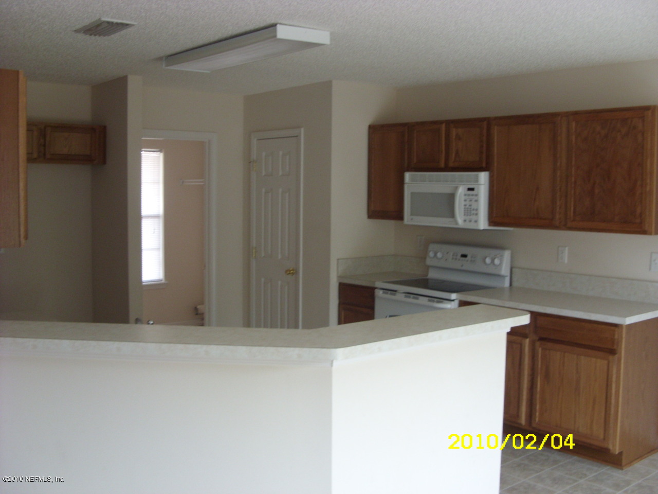 2962 Ravine Hill Drive Middleburg, FL 32068 - Photo 4 of 7 a kitchen with a refrigerator and a stove top oven