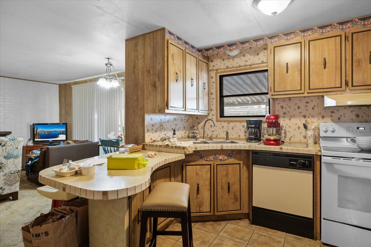 301 Freeman Road, Unit 92 Central Point, OR 97502 - Photo 11 of 16 a kitchen with a sink cabinets and wooden floor