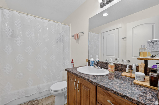 141 Wolverine Creek Elk Ridge, UT 84651 - Photo 21 of 47 Full bath with vanity, shower / bath combination with curtain, and light tile patterned floors
