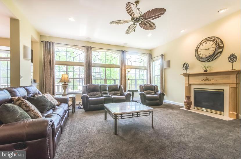 615 Sand Road Severn, MD 21144 - Photo 12 of 30 a living room with furniture a clock and a large window