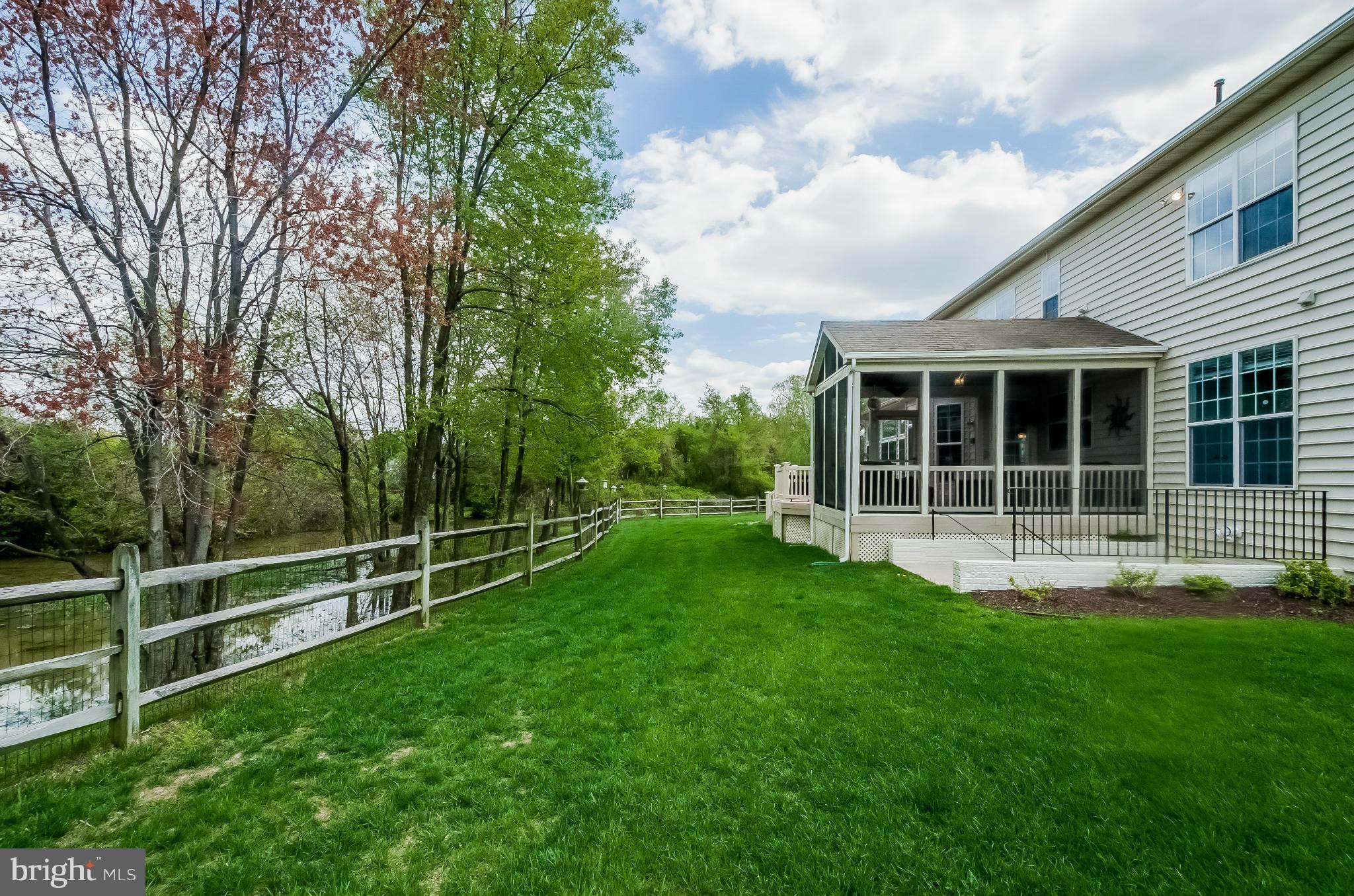 615 Sand Road Severn, MD 21144 - Photo 14 of 30 a view of a backyard with wooden fence and a large tree