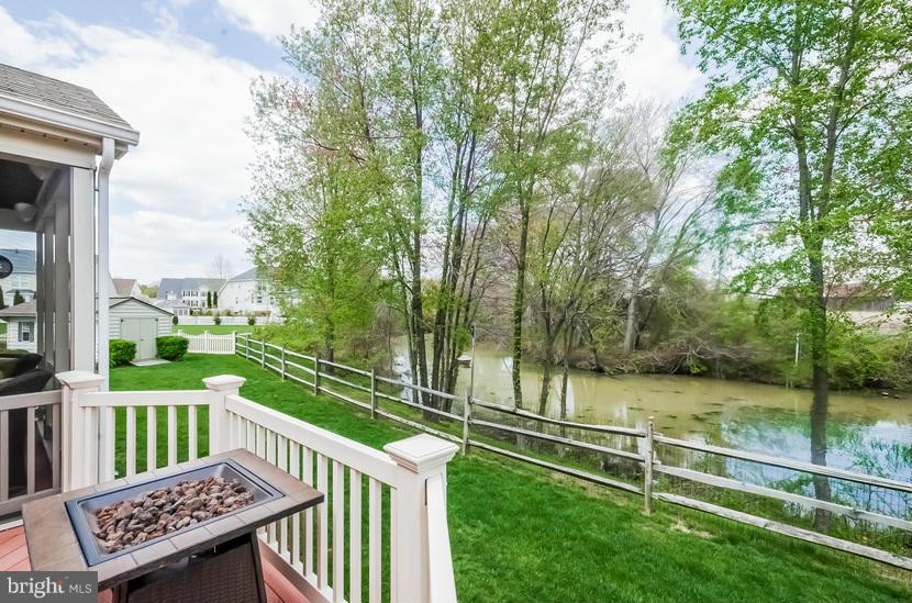 615 Sand Road Severn, MD 21144 - Photo 19 of 30 a view of a wooden deck with large trees