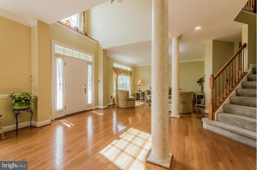615 Sand Road Severn, MD 21144 - Photo 3 of 30 a view of a hallway with wooden floor and furniture