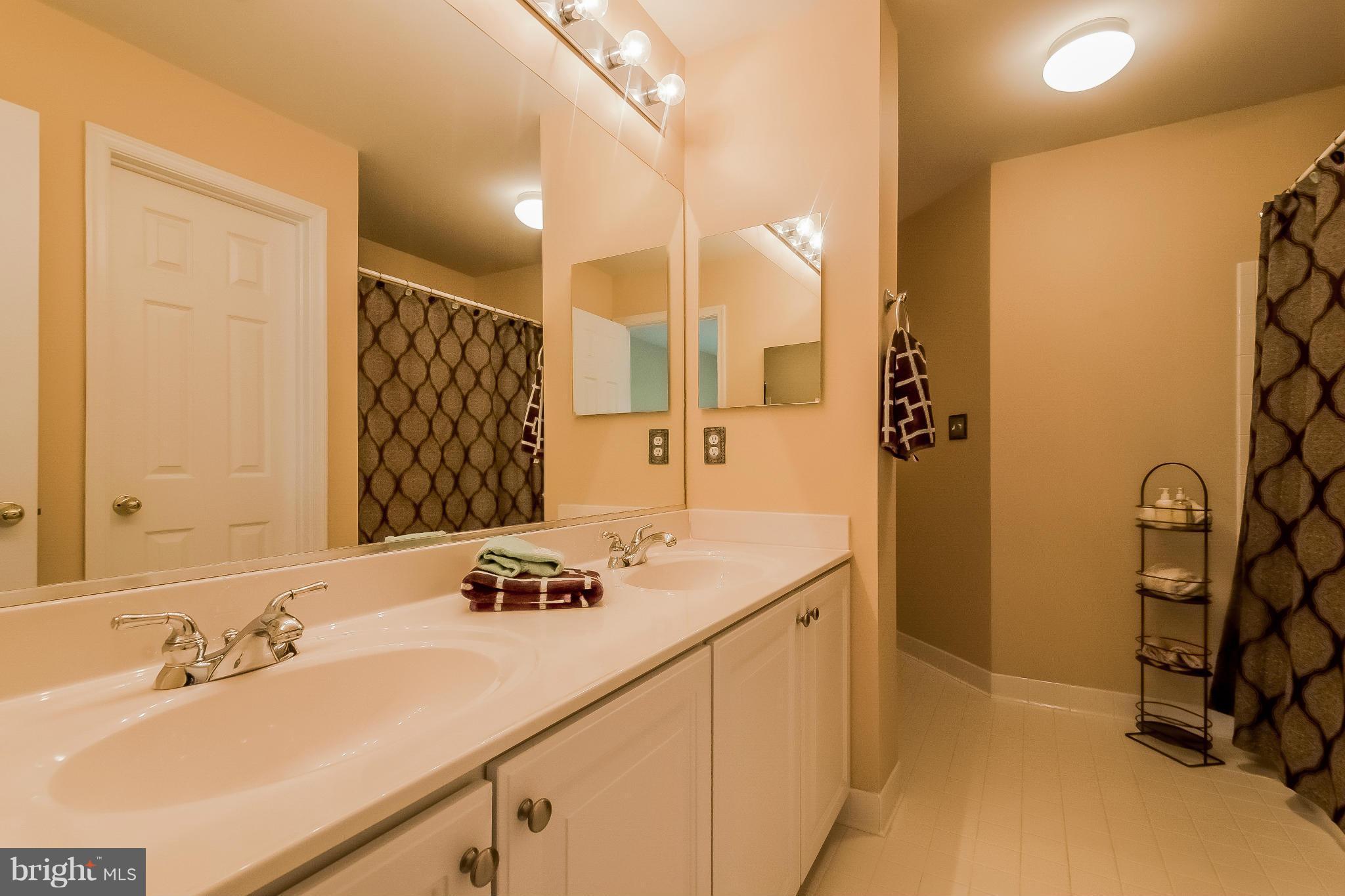 615 Sand Road Severn, MD 21144 - Photo 21 of 30 a bathroom with a sink double vanity and a mirror