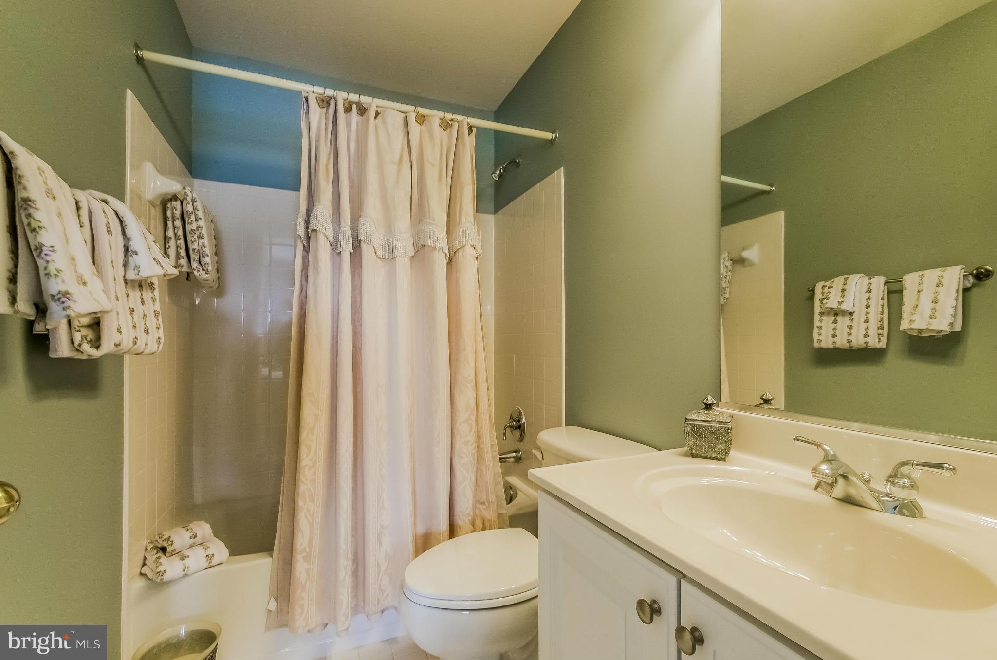 615 Sand Road Severn, MD 21144 - Photo 22 of 30 a bathroom with a sink a toilet and shower curtain
