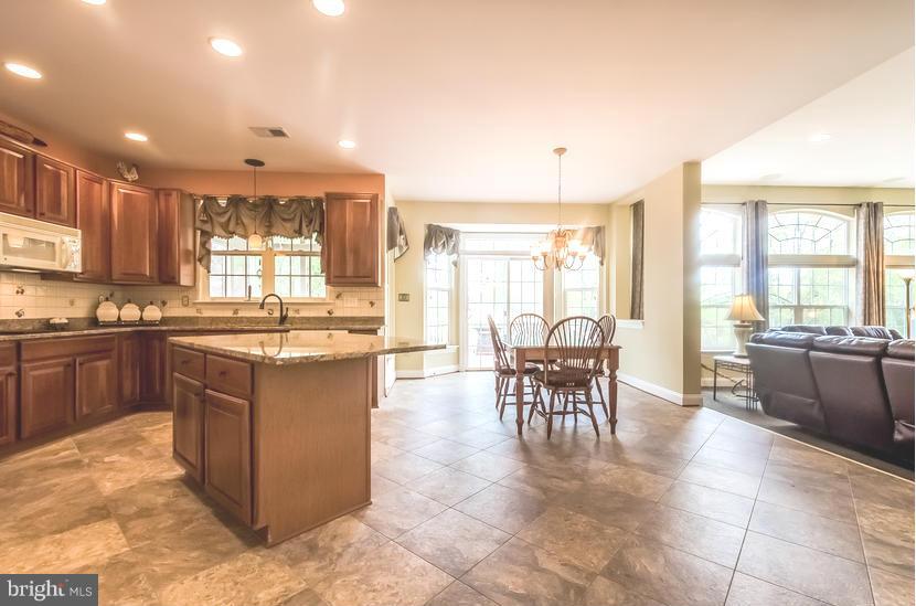 615 Sand Road Severn, MD 21144 - Photo 7 of 30 a kitchen with a large counter top space appliances and cabinets