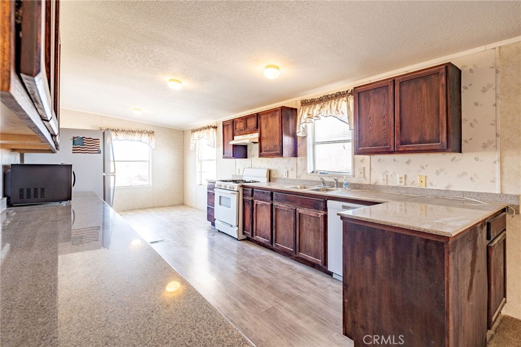 36249 Campbell Road Lucerne Valley, CA 92356 - Photo 11 of 32 a kitchen with a stove sink and cabinets