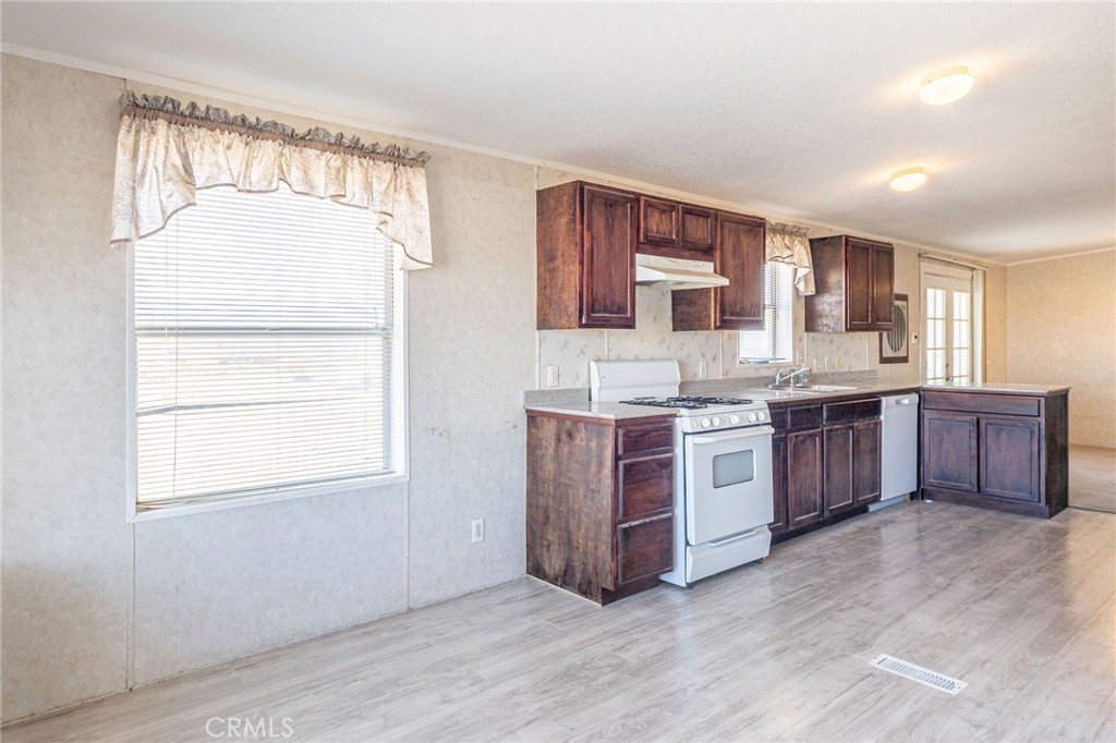 36249 Campbell Road Lucerne Valley, CA 92356 - Photo 14 of 32 a large kitchen with a large window and a sink