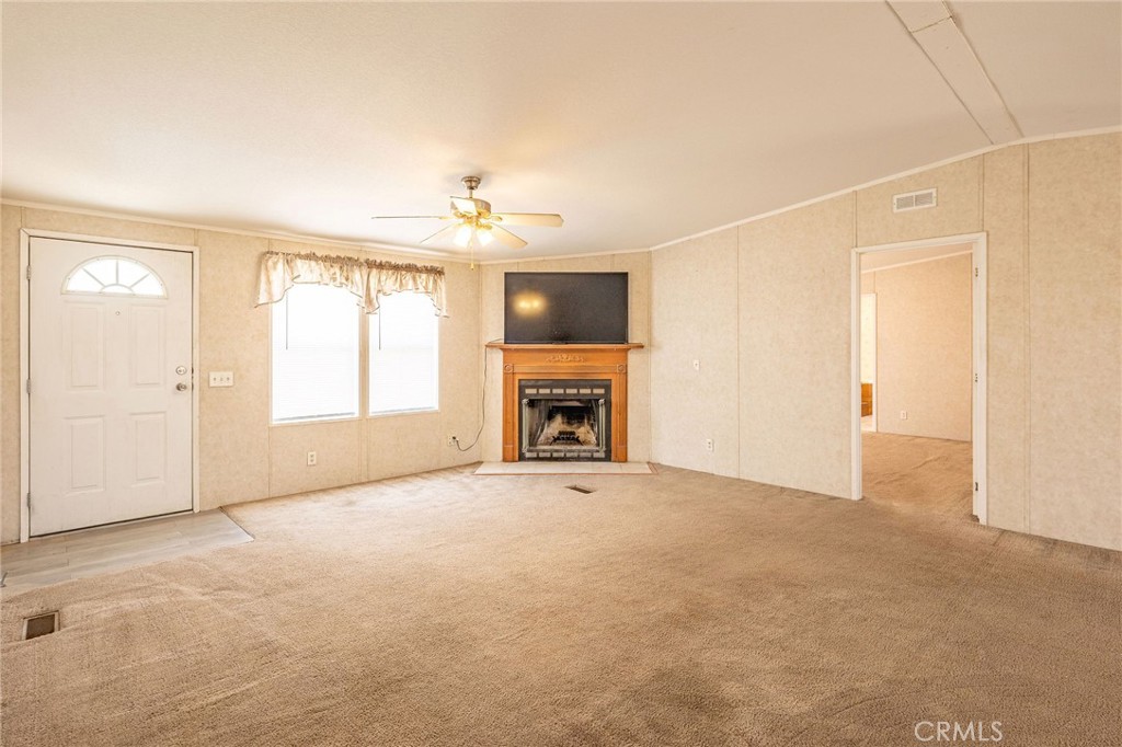 36249 Campbell Road Lucerne Valley, CA 92356 - Photo 5 of 32 an empty room with windows and fireplace