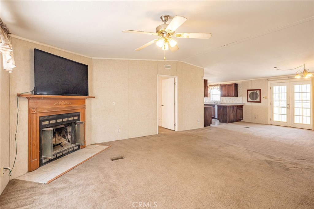 36249 Campbell Road Lucerne Valley, CA 92356 - Photo 6 of 32 a view of empty room with a fireplace and a ceiling fan