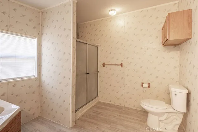 a bathroom with a toilet and a shower
