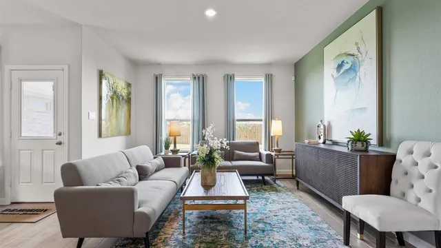 a living room with furniture and a potted plant