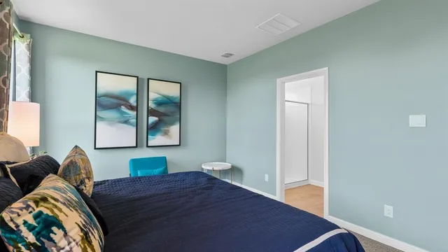 a bedroom with a large bed and a window