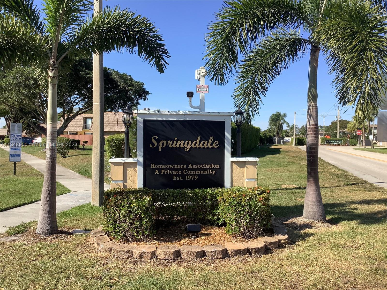 464 Springdale Circle, Unit 46D Palm Springs, FL 33461 - Photo 1 of 21 a sign on the side of the building